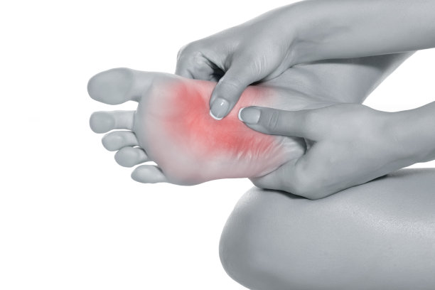 女人按摩她疼痛的脚在白色的背景图片下载