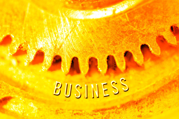 黄金齿轮。金色背景与铭文业务齿轮。商业设计的概念性照片。财富理念、成功理念、永恒理念、团队精神。图片下载