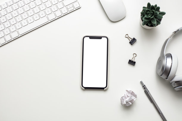 俯视图的办公室桌子桌子模拟智能手机和现代配件，供应在白色背景库存照片图片下载
