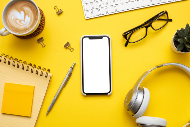 白色屏幕上的彩色背景智能手机的模型。平躺，俯视图的办公桌库存照片图片下载