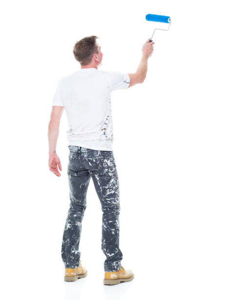 白人年轻男性房屋油漆工站在白色背景前，拿着油漆滚筒图片下载