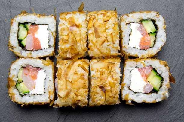 寿司鲣鱼卷的特写在一个黑暗的背景。寿司俯视图。寿司食物图片菜单。图片下载