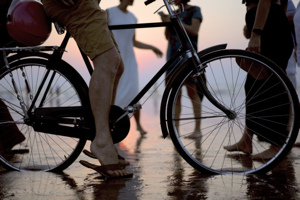 一个男人在海边骑自行车。阿拉伯海。夏天，海边，度假，放松海滩。图片下载