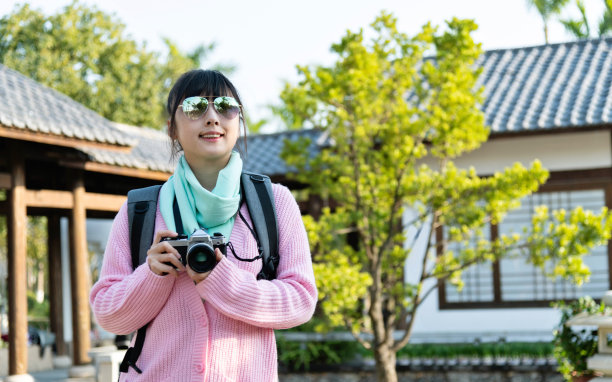 一位正在拍摄中国古代建筑照片的妇女图片下载