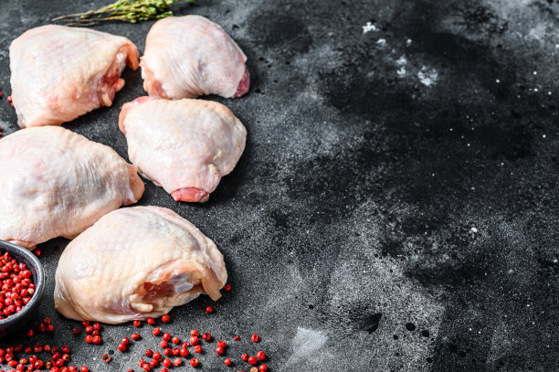 新鲜鸡腿，有机家禽肉。黑色背景。前视图。本空间图片下载