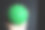 一只男性的手在自然光下握着一个绿色的尖点按摩球。图片下载