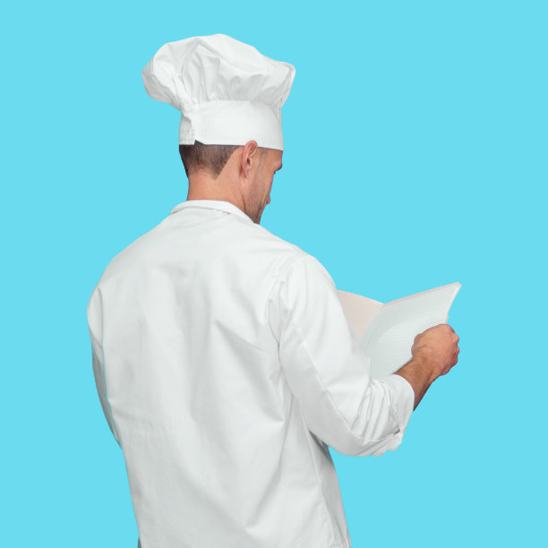 白人男厨师穿着制服，手持文件站在蓝色背景前图片下载