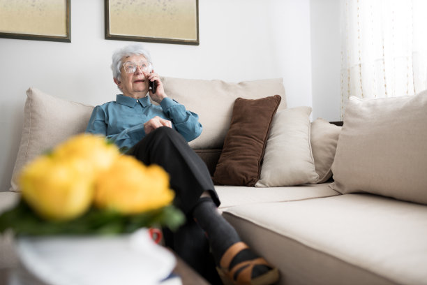 微笑着在家里打电话的资深女士图片下载