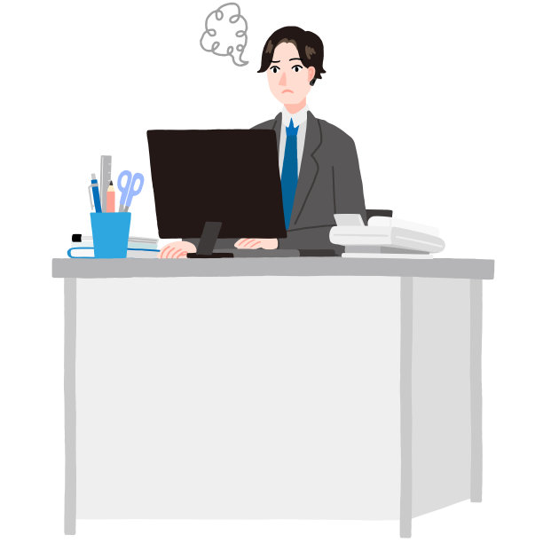 一个年轻人坐在他的办公桌前，在他的电脑上工作图片下载