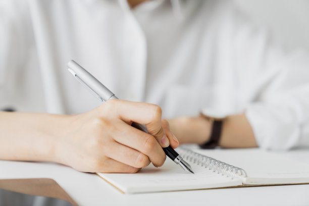 在家里桌子上的空白笔记本上手写的特写。图片下载