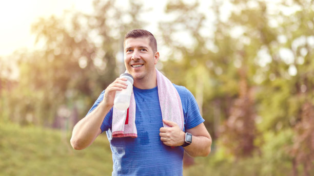 标题:流汗的成熟慢跑男子慢跑后喝水图片下载