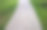 花岗岩铺砌不规则分段的碎石路，公园周围有绿色草坪灰色的人行步道图片下载