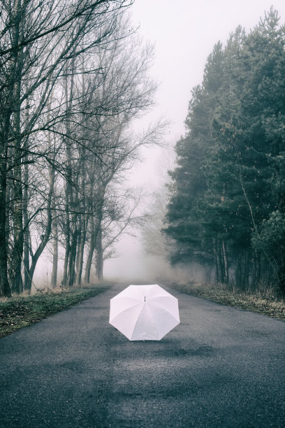 白色的伞躺在公路上图片下载