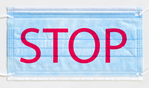 阻止病毒和流行病。蓝色卫生口罩，上面写着"停止"图片下载