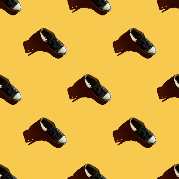 球鞋无缝模式上的黄色背景。夏季最小的概念。鞋类的背景。图片下载