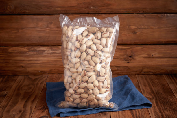 有机干果-无盐开心果包装上的纹理设计背景和亚麻纺织品。素食。图片下载