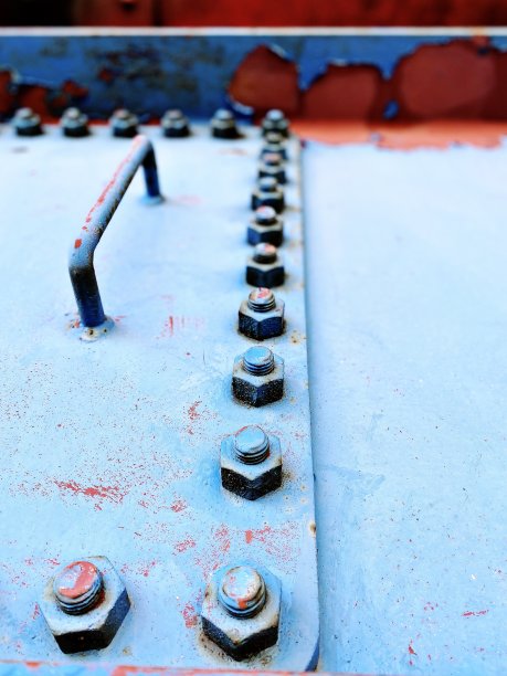 近距离的一个风化的钢梁与螺母和螺栓图片下载