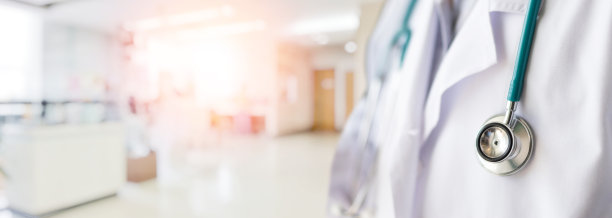 在医院或诊所与COVID-19作战的医生或医师身穿白袍制服，佩戴听诊器为背景旗帜图片下载