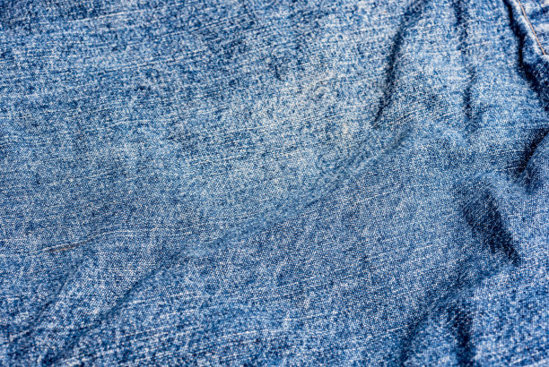 蓝色牛仔裤面料。牛仔牛仔裤纹理牛仔牛仔裤的背景。牛仔服装设计。高跟鞋。缝合。照片的背景。图片下载
