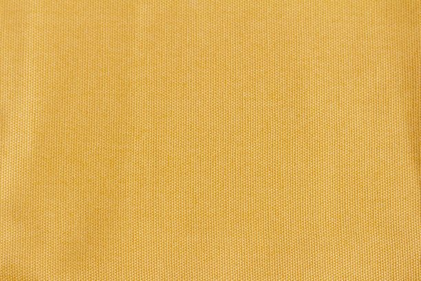 质地浓密的棉织物呈黄色或芥末色。用于设计和装饰的织物纹理。图片下载