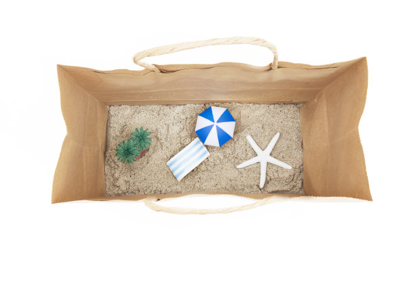 迷你玩具沙滩，有躺椅，棕榈树，遮阳伞和一个纸袋里的白色海星。图片下载