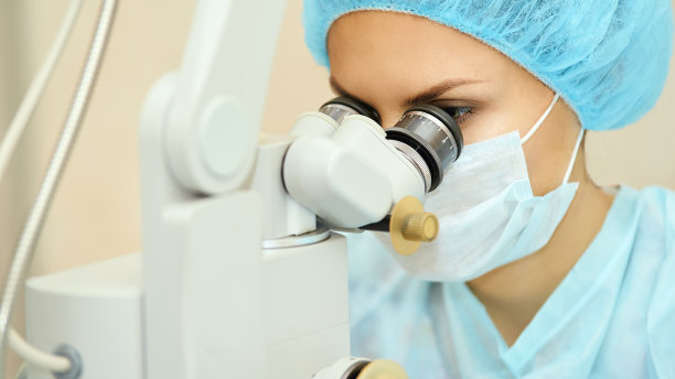 漂亮的女医生肖像。眼科激光显微镜手术。诊所的房间。病人的眼睛治疗。近视及白内障摘除图片下载