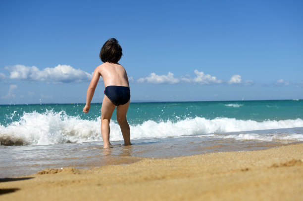 小男孩在海滩上享受图片下载