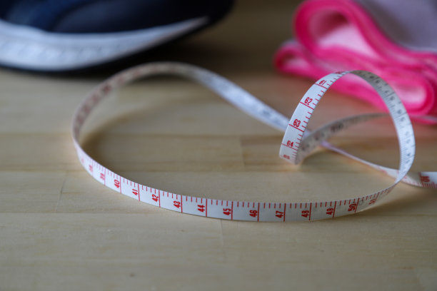 卷尺在木制背景下的卷尺图片下载