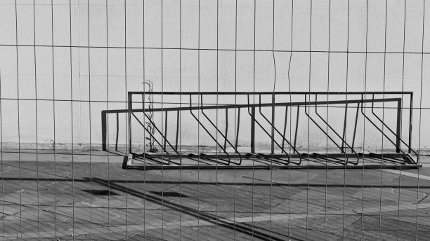 金属栅栏后生锈的自行车架(意大利，Pesaro，欧洲)图片下载