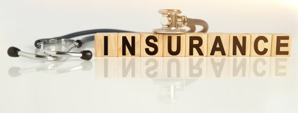 保险字在木方上，木方立在反光的白色表面上，木方上——听诊器。图片下载