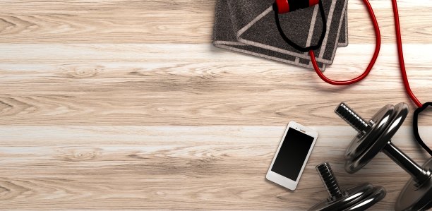 有哑铃和智能手机的健身背景。从上面的观点图片下载