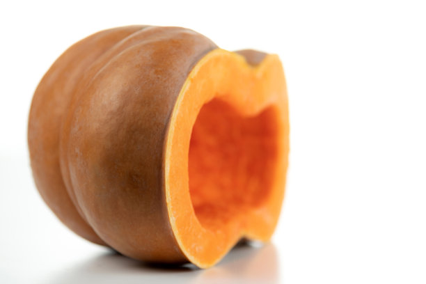 熟透的橙色南瓜切成两半，孤立在白色背景上。图片下载