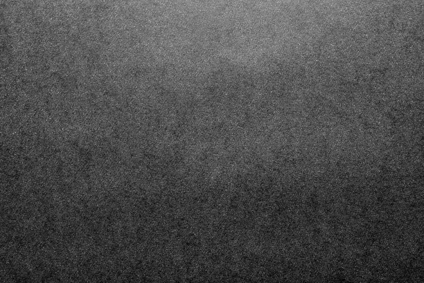 黑白背景由真正的黑色纸和白点，由柔和的光从上面照亮。图片下载