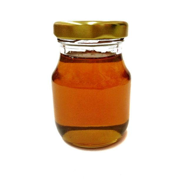 白色背景上的蜂蜜玻璃瓶。图片下载