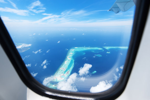 从飞机窗口俯瞰热带岛屿和绿色泻湖图片下载