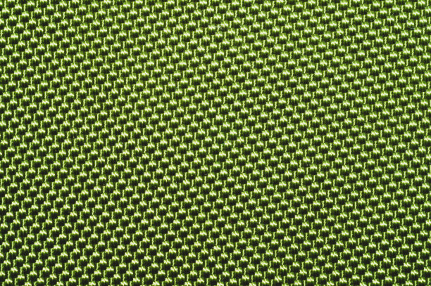 绿色合成材料。近距离观察织物质地。编织的背景。辫状表面。针的纤维图片下载