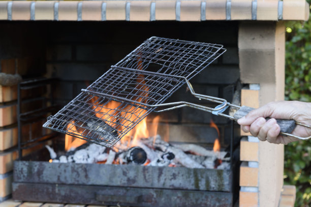 用火焰点燃烧烤，准备在外面烧烤食物。在花园里吃。图片下载