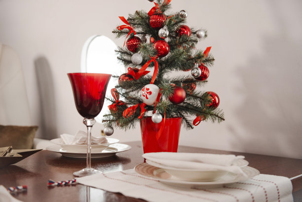 飞机上的餐桌，盘子，红色的玻璃，装饰过的圣诞树，机舱的飞机图片下载