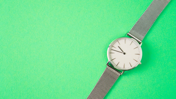 灰色手表上的绿色背景。孤立的女人看。时间是流逝的概念。看广告图片下载