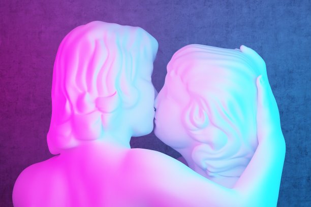 在粉蓝色灯光下接吻的情侣雕塑图片下载