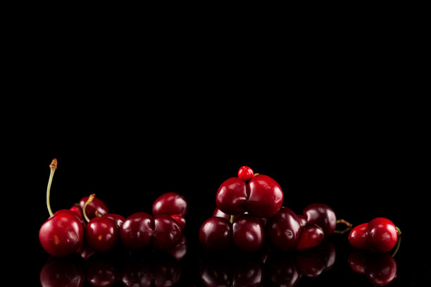概念-减少食物浪费。一堆新鲜的双份樱桃(樱桃)在黑暗的背景反射。有选择性的重点。难看的樱桃可以用来做蜜饯或果酱图片下载