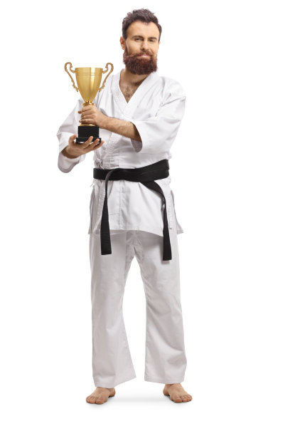 一个完整的长度肖像的空手道冠军在和服与奖杯图片下载