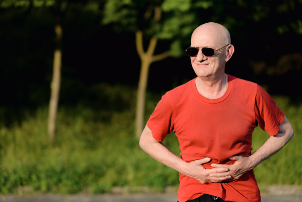 老人胃疼，在大自然中摸着自己的胃图片下载