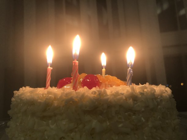 用五颜六色的糖屑和十支蜡烛装饰的生日蛋糕图片下载