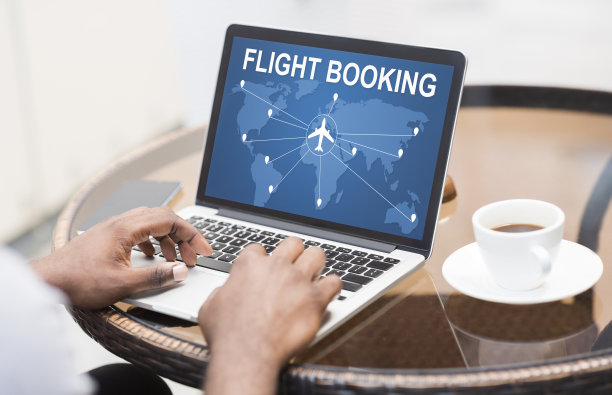 一个非洲人坐在咖啡馆的笔记本电脑前买机票图片下载