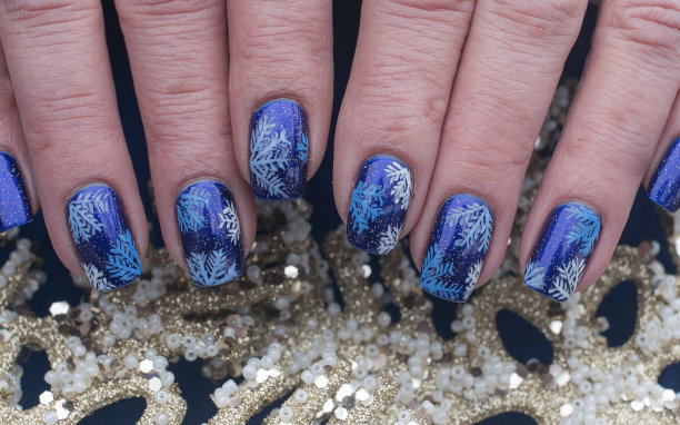 蓝色指甲油上的雪花艺术设计图片下载