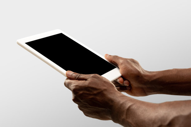 在网上观看世界各地流行的体育比赛和锦标赛时，男性手握平板电脑，屏幕为空白。Copyspace广告图片下载