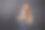 一个欧洲女孩，穿着灰色上衣和牛仔裤，金色长发，侧着身子站着，手放在脑后，直视着墙壁图片下载