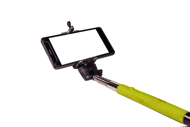 自拍杆与现代智能手机隔离在白色背景图片下载