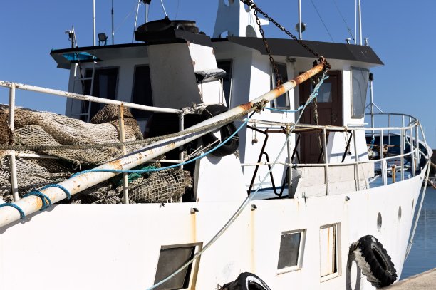老式白色渔船，有捕鱼设备和轮胎作为挡泥板(意大利，欧洲)图片下载